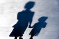 Blurry vintage shadows silhouettes of two person walking in the night