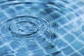 Blurry water drop on blue swimming pool water surface Royalty Free Stock Photo