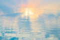 Water ripple circle on the surface of lake water with reflection of sky clouds at sunset or evenig time. Royalty Free Stock Photo