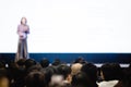 Blurry of woman speaker speech on stage in auditorium for shareholders` meeting Royalty Free Stock Photo