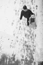 Blurry woman walking while pulling a shopping trolley bag during snowfall, high angle view