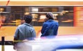 Blurry young men waiting at bus stop Royalty Free Stock Photo