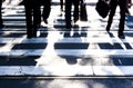 Blurry zebra crossing with pedestrians walking shadows