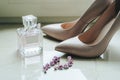 Blush pink bridal shoes and bottle of perfume. Close up and top view.The bride`s shoes and perfume. Heeled shoes. Pink fragrance. Royalty Free Stock Photo