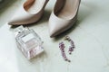 Blush pink bridal shoes and bottle of perfume. Royalty Free Stock Photo