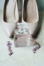 Blush pink bridal shoes and bottle of perfume. Close up and top view. Royalty Free Stock Photo