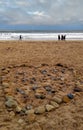 Blyth Beach winter day walk. The heart made from the stones on the beach. Sea and cloudy sky in the blurry background. Royalty Free Stock Photo