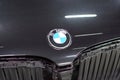 The BMW car, covered with a protective shiny black paint film, is in a repair shop, blurred focus. Chelyabinsk, Russia, May 07,