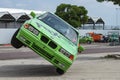 BMW car rides sideways on two wheels, at an auto show in the city of Halle Saale, Germany, 04.082019