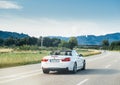 BMW convertible cabriolet car driving fast on the rural highway Royalty Free Stock Photo