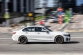 BMW 320d M Sport G20 moving fast on the street of Moscow. BMW 3 Series car rushes on the road with blurred background