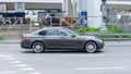 BMW 740 F01 on the road in motion. Fast speed drive on city road in industrial district
