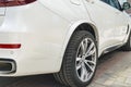 BMW F15 X5 M Perfomance. Tire and alloy wheel. Side view of a white modern luxury sport car. Car exterior details Royalty Free Stock Photo