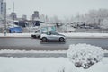 BMW i3 car fast speed driving on the asphalt road in winter