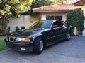 BMW 325i cupÃÂª, cor preta, vista lateral, E36, estacionado, isolado.