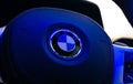 BMW 320i Steering wheel badge under blue light, horizontal.