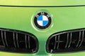 BMW logo on green lime hood of presentable luxury car