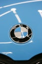 The BMW logo on the hood of the car is sky blue. Close-up, top view. Royalty Free Stock Photo