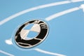 The BMW logo on the hood of the car is sky blue. Close-up, top view. Royalty Free Stock Photo