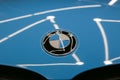 The BMW logo on the hood of the car is sky blue. Close-up, top view. Royalty Free Stock Photo