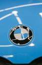 The BMW logo on the hood of the car is sky blue. Close-up, top view. Royalty Free Stock Photo