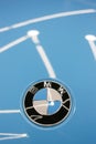 The BMW logo on the hood of the car is sky blue. Close-up, top view.