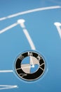 The BMW logo on the hood of the car is sky blue. Close-up, top view. Royalty Free Stock Photo