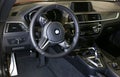 BMW M2 F87 Competition interior and steering wheel. BMW M2 sports car with Performance Pack, interior view. Royalty Free Stock Photo
