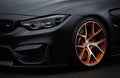 BMW M4 F83 wrapped in matte black vinyl wrap and equipped with custom wide body kit and forged wheels with low Royalty Free Stock Photo