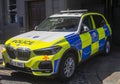 A BMW police vehicle in Hi-Viz livery parked close to Windsor castle in Berkshire England while the Bobbies engage in crowd contrl