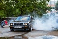 BMW 3-series driftcar burning tires in drift-show Royalty Free Stock Photo