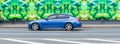 BMW 3 series F30 car moving on the street. Blue sedan BMW in blurred motion, side view Royalty Free Stock Photo