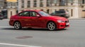 BMW 3 Series F30 car moving on the street. Red sedan BMW in blurred motion, front side view Royalty Free Stock Photo