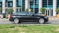 BMW 5 Series F07 Gran Turismo riding the streets. Panning shot of black shiny car running on the city road Royalty Free Stock Photo