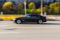 BMW 7 Series F01 on the road in motion. Fast speed drive on city road