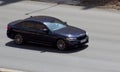 BMW 5series rides on the road Royalty Free Stock Photo