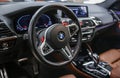 BMW X3 M Competition steering wheel and dashboard. Beige leather car interior. Vehicle interior SUV.