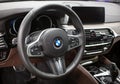 BMW X5 steering wheel and dashboard. Beige leather car interior.