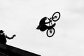 BMX bike jumping in the sky on high speed, black and white silhouette. Extrem Sport Royalty Free Stock Photo