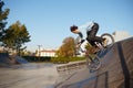 Bmx biker doing trick on ramp in skatepark Royalty Free Stock Photo