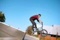 Bmx biker doing trick on stairs in skatepark Royalty Free Stock Photo