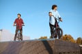 Bmx biker standing on ramp, training in skatepark Royalty Free Stock Photo