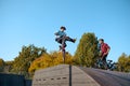Bmx bikers jumps on ramp, training in skatepark Royalty Free Stock Photo