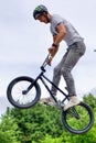 BMX freestyle teenage biker jumping over ramp Royalty Free Stock Photo