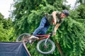 BMX freestyle teenage biker jumping from ramp Royalty Free Stock Photo