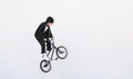 BMX freestyle. Young BMX bicycle makes tricks on the white background. Copyspace