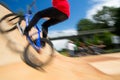 Bmx rider jumping over on a U ramp in a skatepark Royalty Free Stock Photo