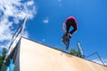 Bmx rider jumping over on a U ramp in a skatepark