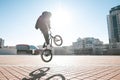 rider makes a trick on the street on a sunny day. Street bmx freestyle Royalty Free Stock Photo