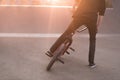 Bmx rider performs tricks on a bmx bike in a skate park on the background of the sunset. Bmx Concept. Copyspace Royalty Free Stock Photo